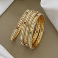 Elegant Pearl Beaded Gold Toned Bangle Set with Kundan Stones