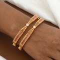 Traditional Gold Jaali Work Bangles with Pink Accents